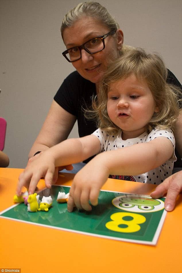 Young girl and mum doing a fun math activity
