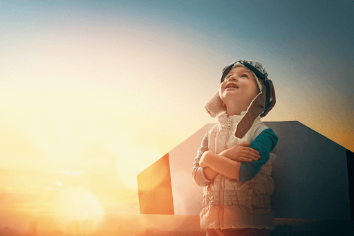 A young child imagining a bright future