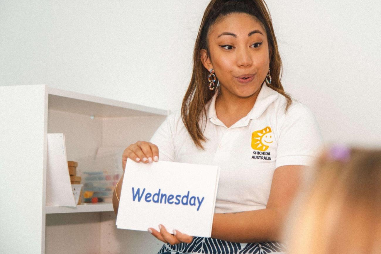 Instructor showing sight word flash cards in a Shichida class