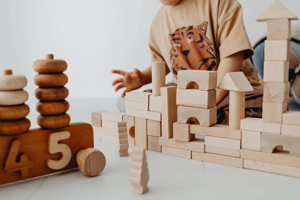 Block play time - a child playing with wooden blocks