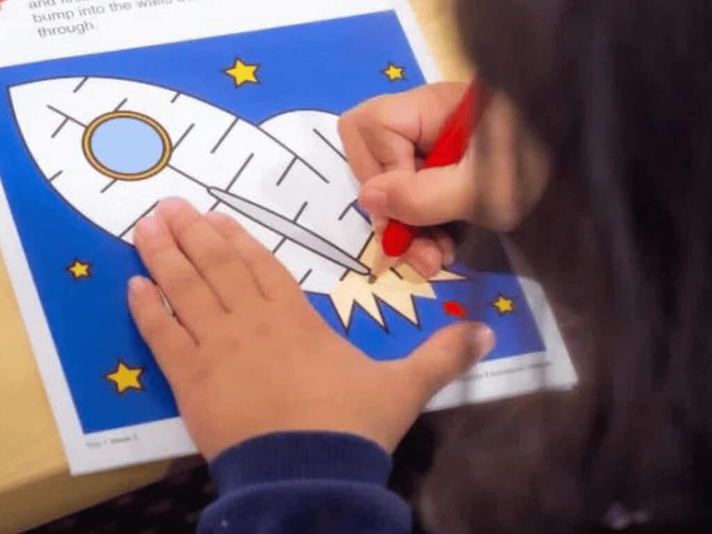 Scissor skills development, featuring a child completing a maze, developing finger strength and dexterity, which are important for scissor control.