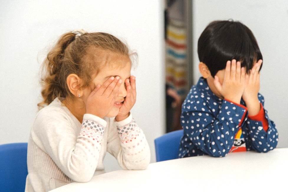 Emotional Regulation Activities for Kids, here 2 preschoolers are closing their eyes in a Shichida class, while practising visualisation.