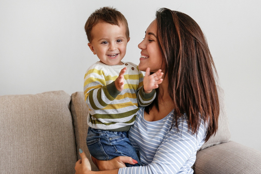 How to Build Child's Confidence, featuring a mum holding her young son. They both look happy.