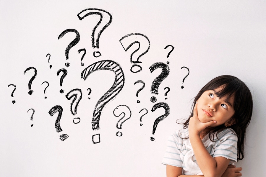 Curious kids, featuring a young girl thinking, with question marks surrounding her.