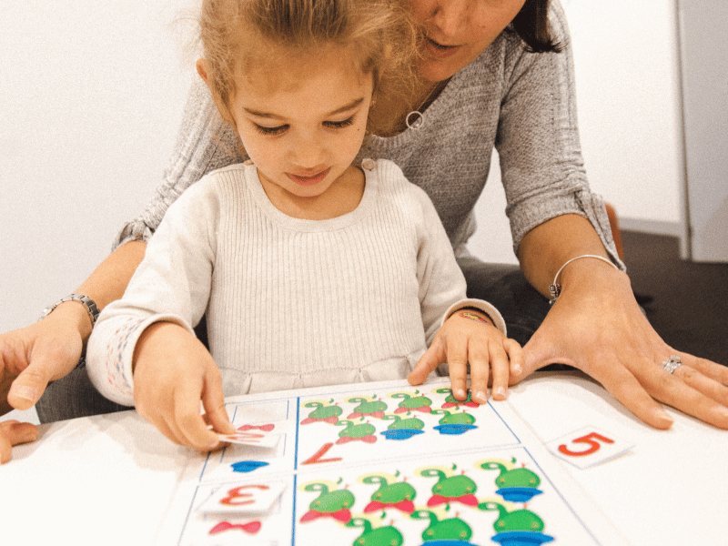 Maths activities for kids, featuring a mum and preschooler completing a math activity together.