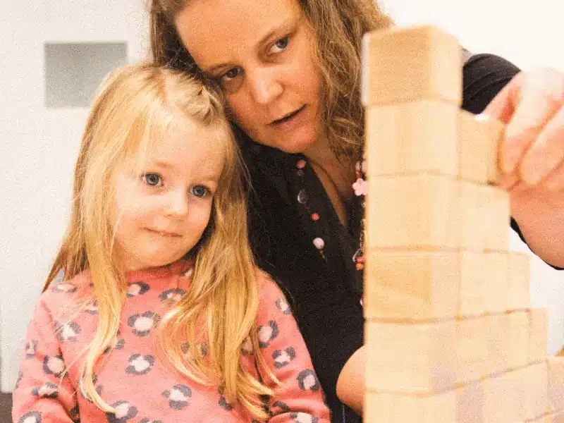 Parenting styles, featuring a mum and preschool daughter playing with building blocks.