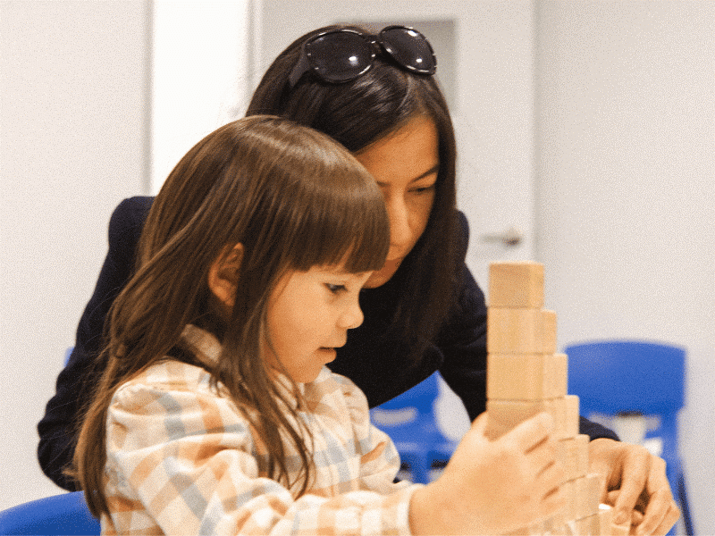 Stages of Child Development Guide, featuring a mum and her child building blocks together in a Shichida class