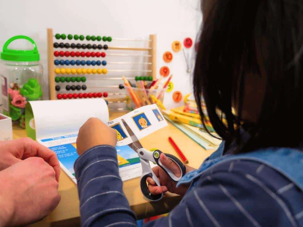 Photo by SHICHIDA at Home Cutting is a great way to strengthen hand muscles for writing activities.