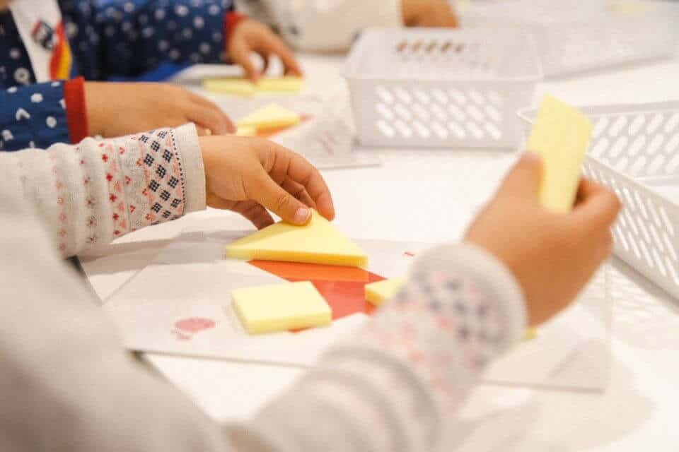 Preschoolers solving a fun 3D Tangram puzzle challenge. This activity develops critical thinking, fine motor control, pattern recognition and spatial awareness.