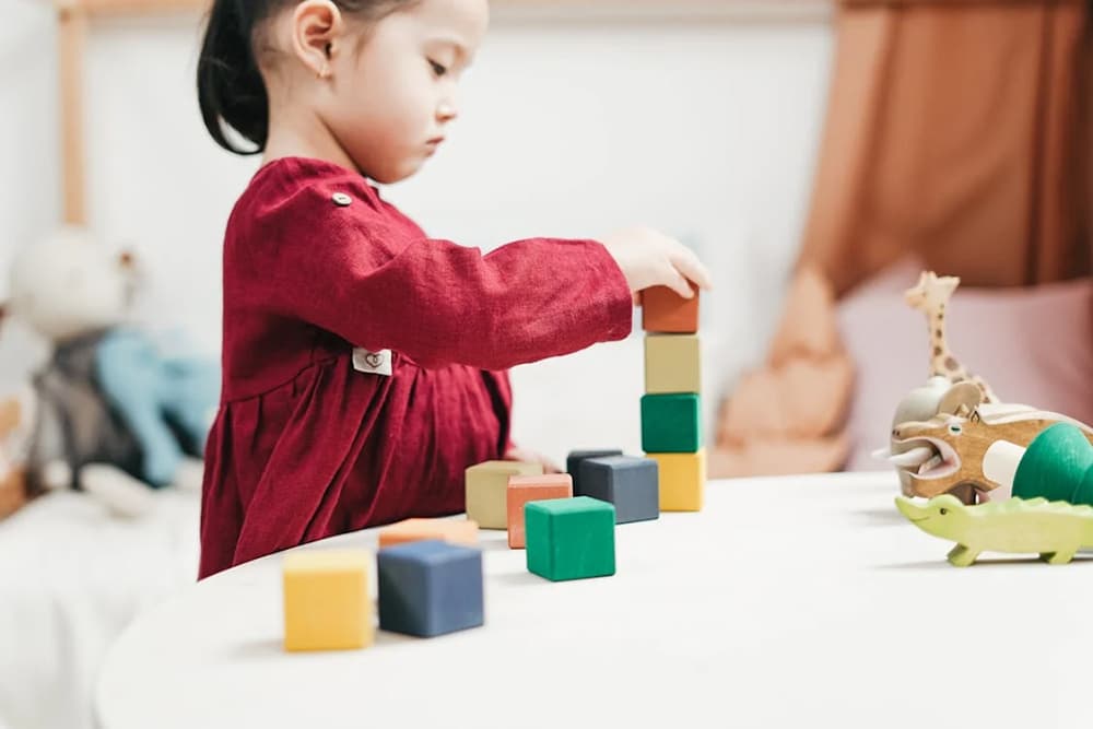 a girl playing with blocks