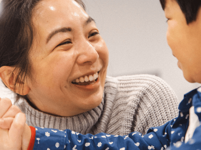 Stages of child development Guide, featuring a mother smiling at her child